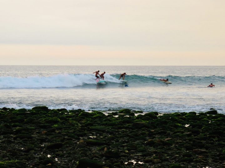 Surfers sharing a wave off the coast near Máncora